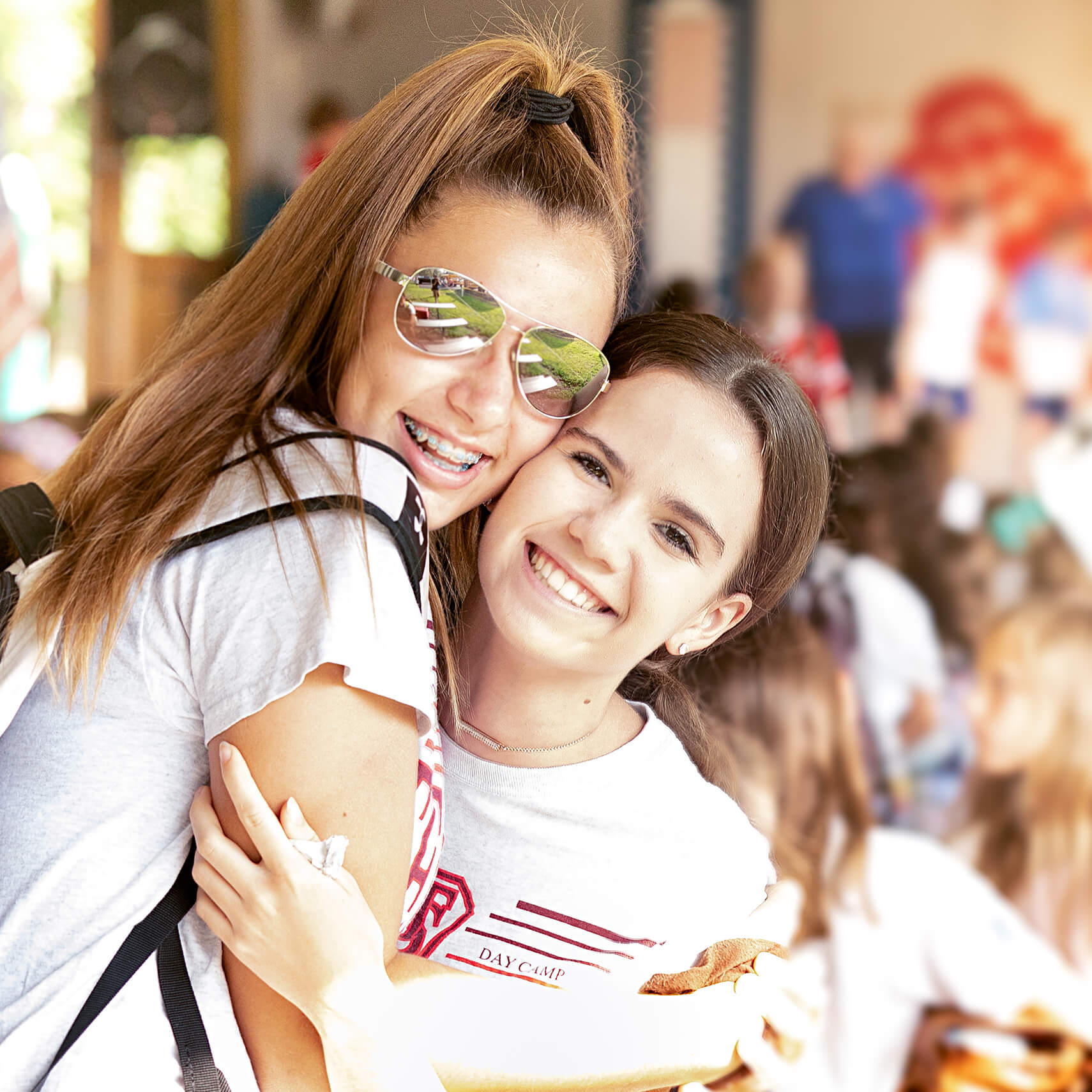 Two girls hugging and smiling.