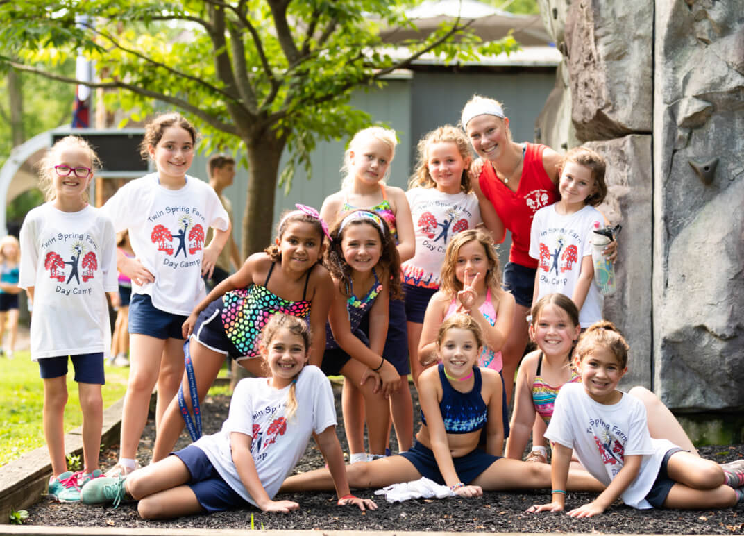 A group of summer campers rock climbing.