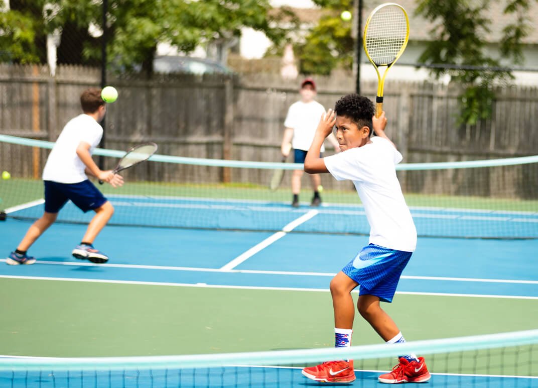 Young athlete playing tennis.