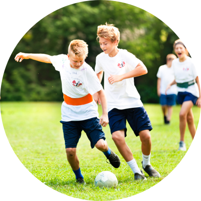 Two boys playing soccer.