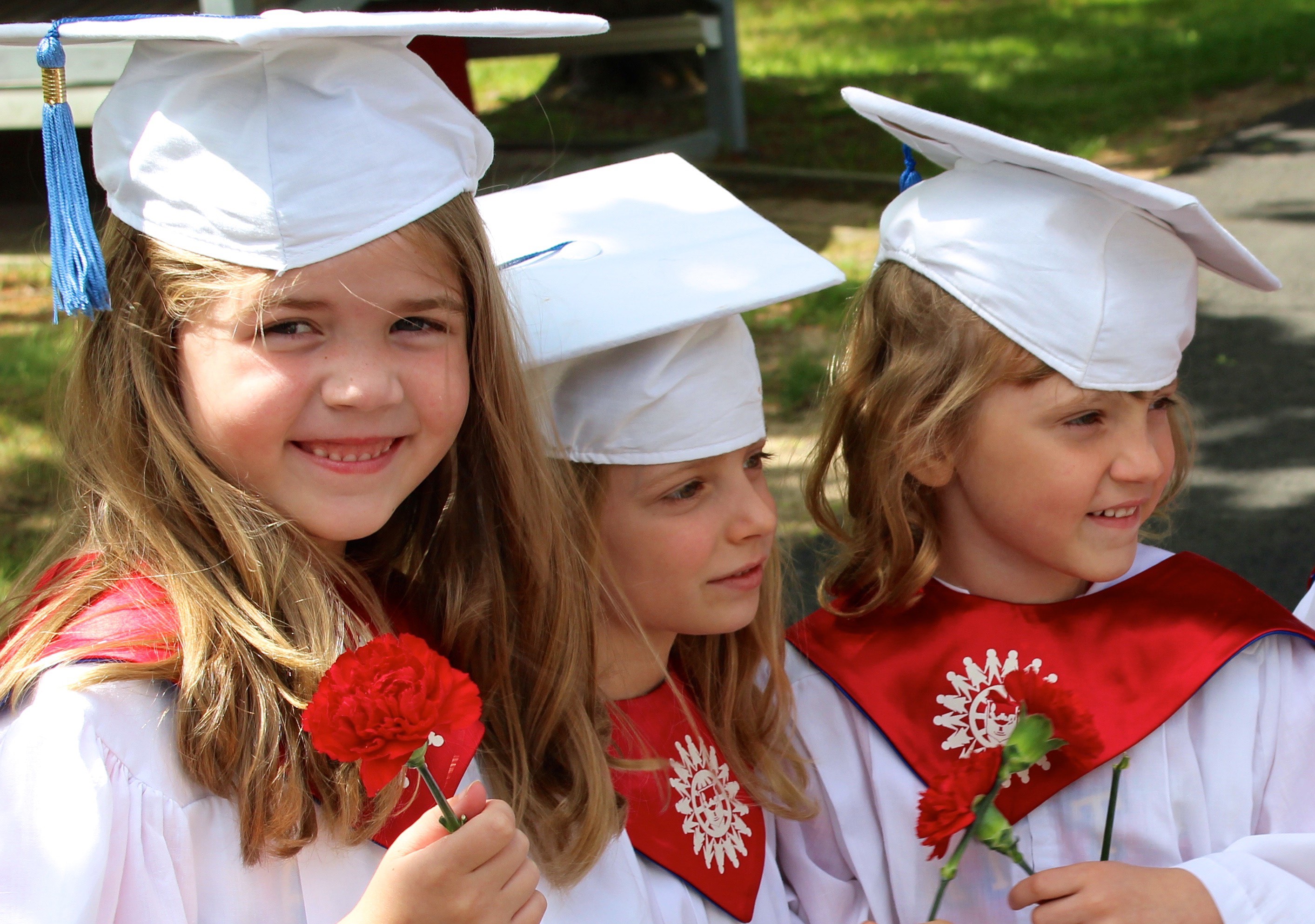 Toddlers in graduation outfits.