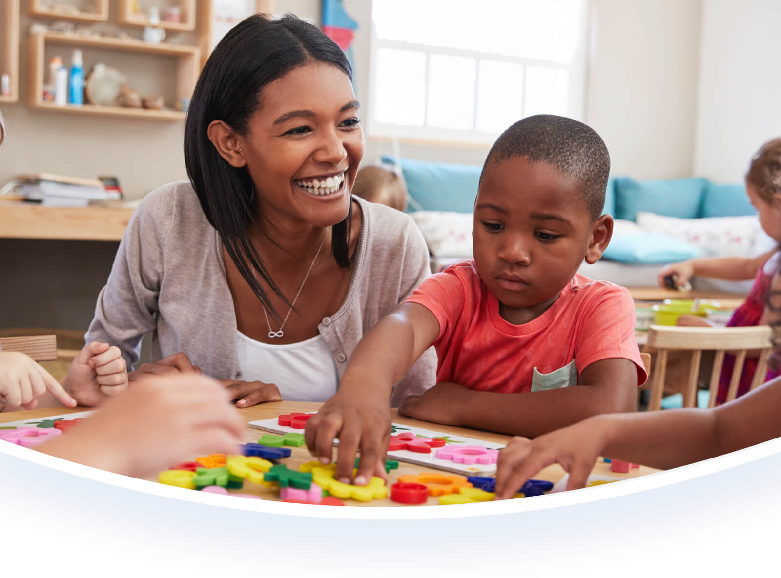 Preschool teacher playing with a student.