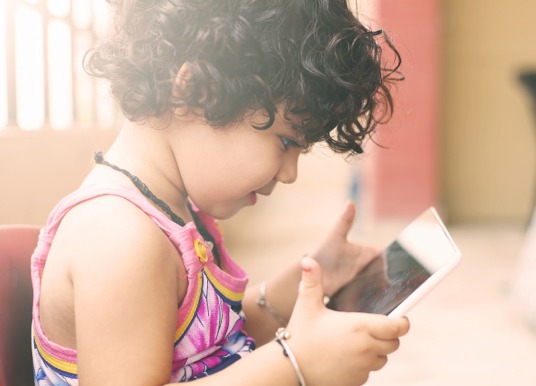 Child playing on a tablet.