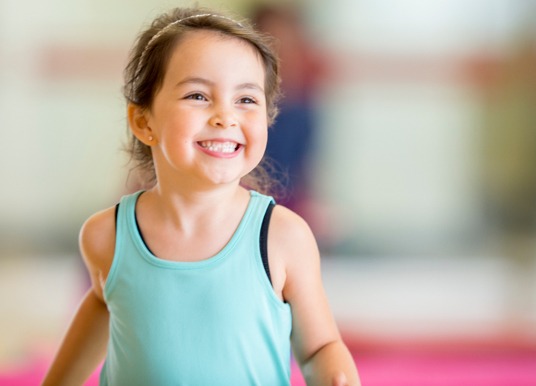 Girl toddler playing in a gym.