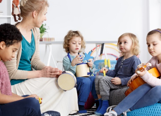 Young students playing instruments.