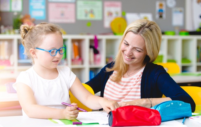 Parent with child in a classroom.