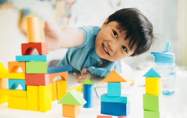 Boy toddler playing with blocks.