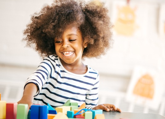 Girl toddler playing with toys.